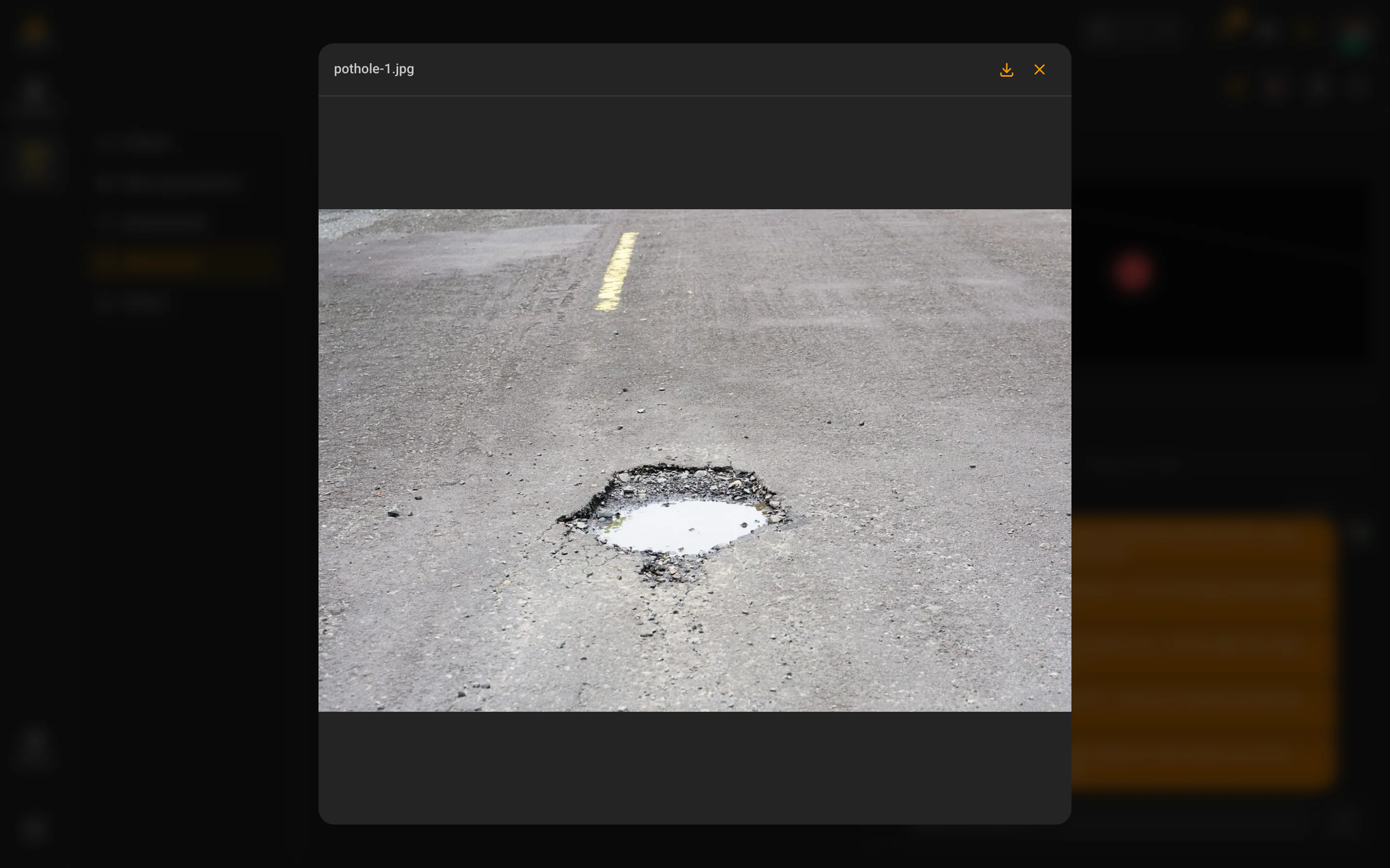 An in-app preview of a road-surface defect photo opened from the report